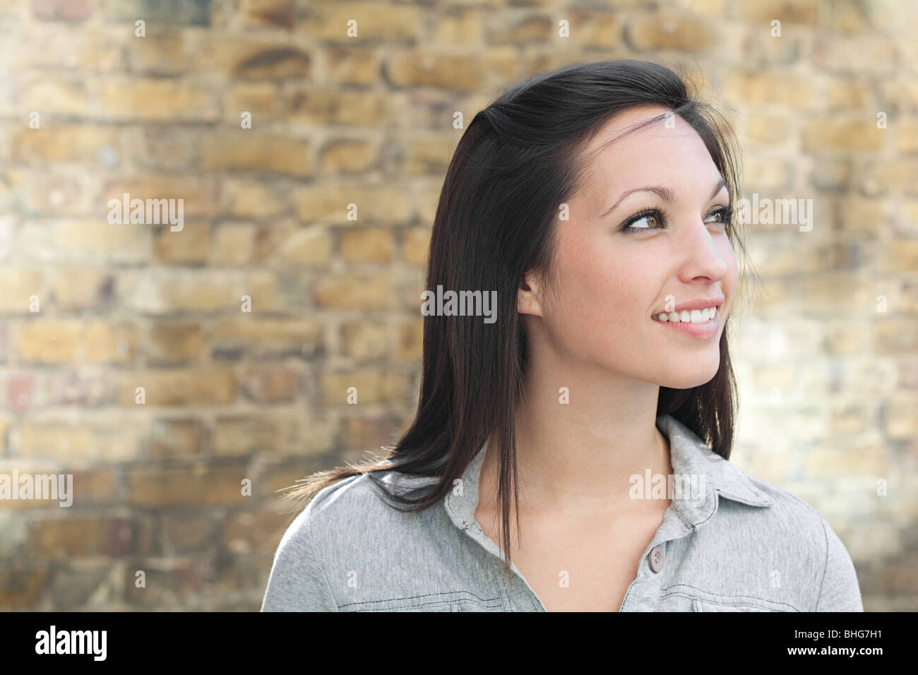 portrait-of-young-woman-in-front-of-wall-stock-photo-alamy