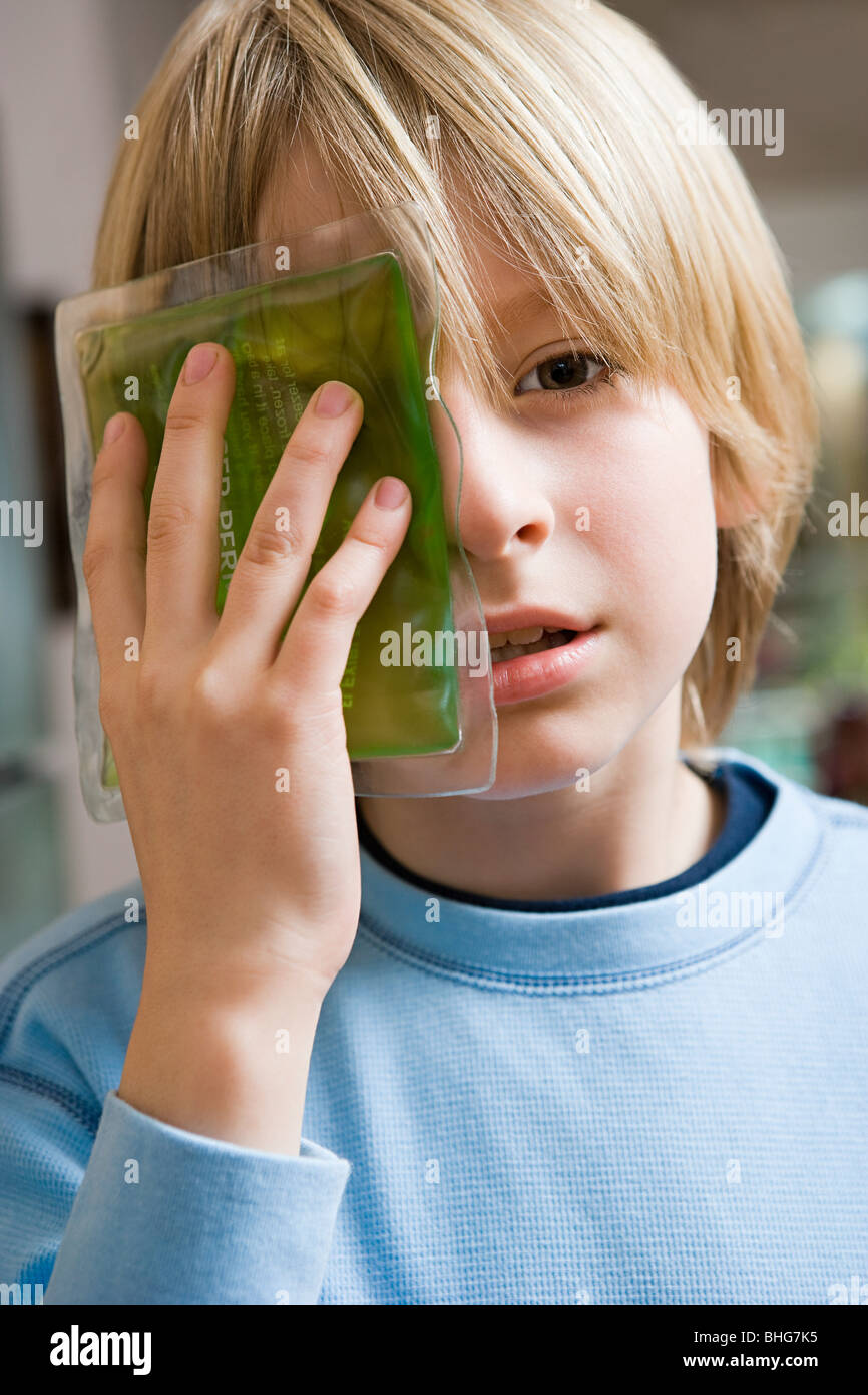 Boy with ice pack on his eye Stock Photo Alamy