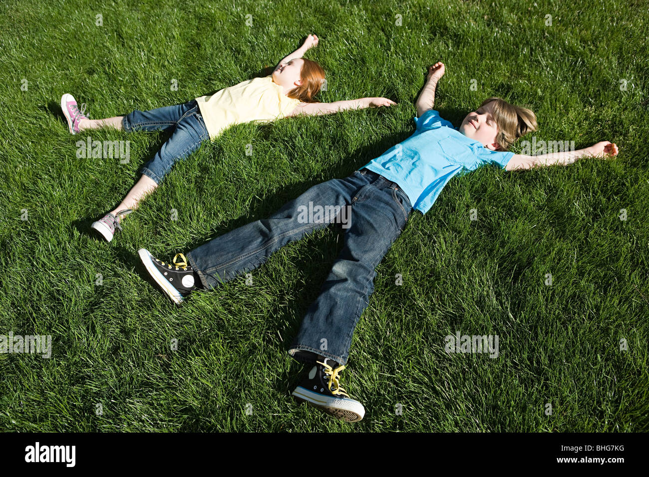 Boy lying on grass arms hi-res stock photography and images - Alamy