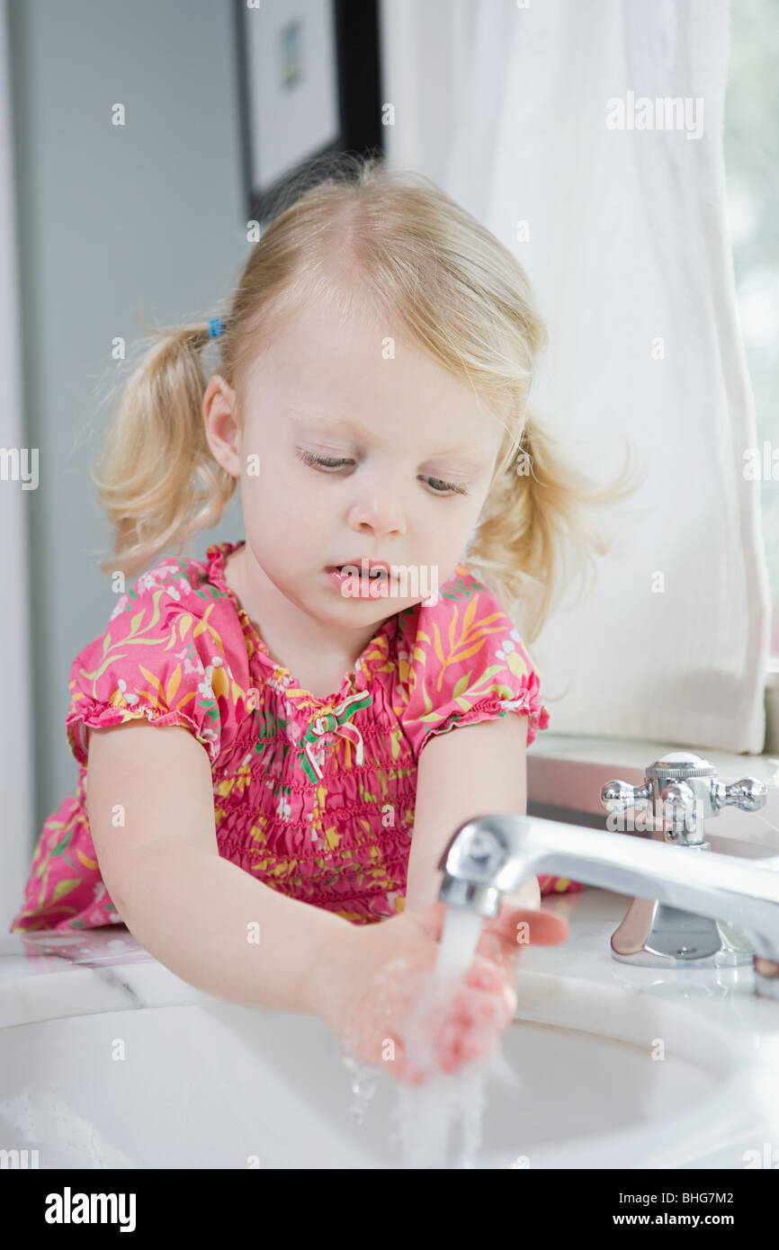 Girl washing her hands Stock Photo - Alamy