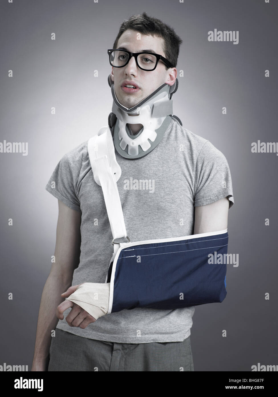 Man with neck brace and arm in sling Stock Photo