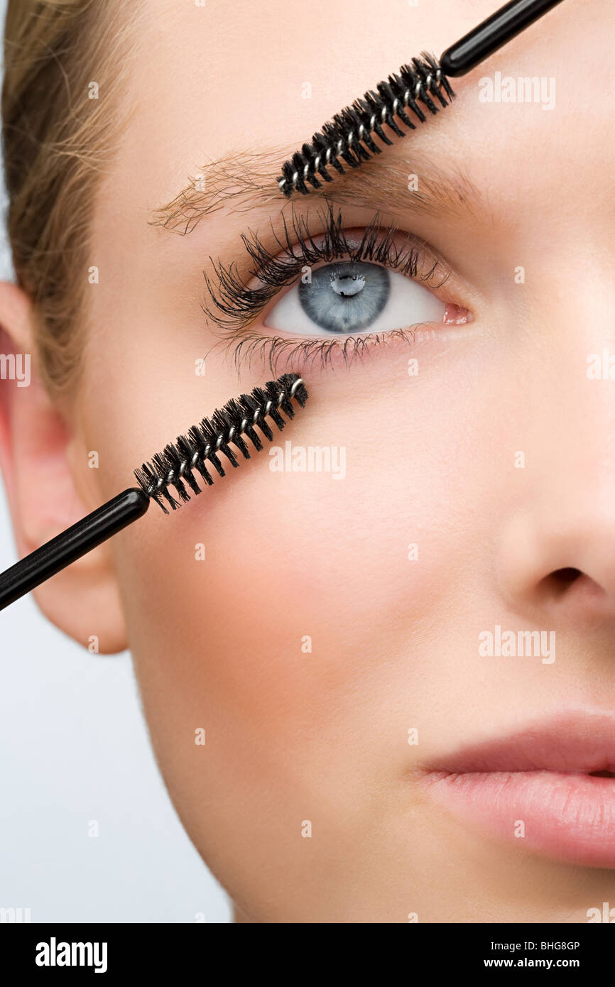 Woman with two mascara brushes Stock Photo Alamy