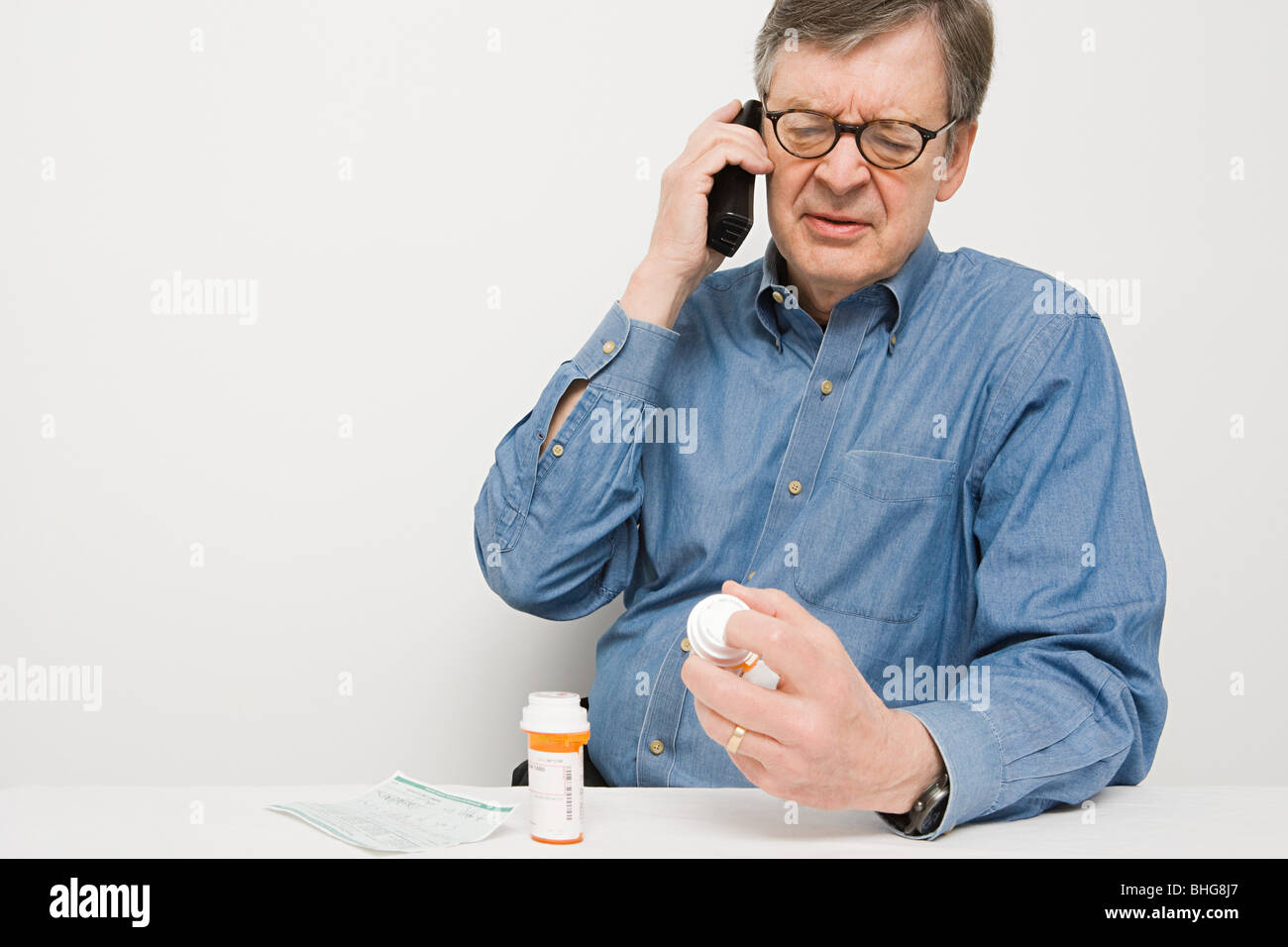 Man on telephone with medicine Stock Photo - Alamy