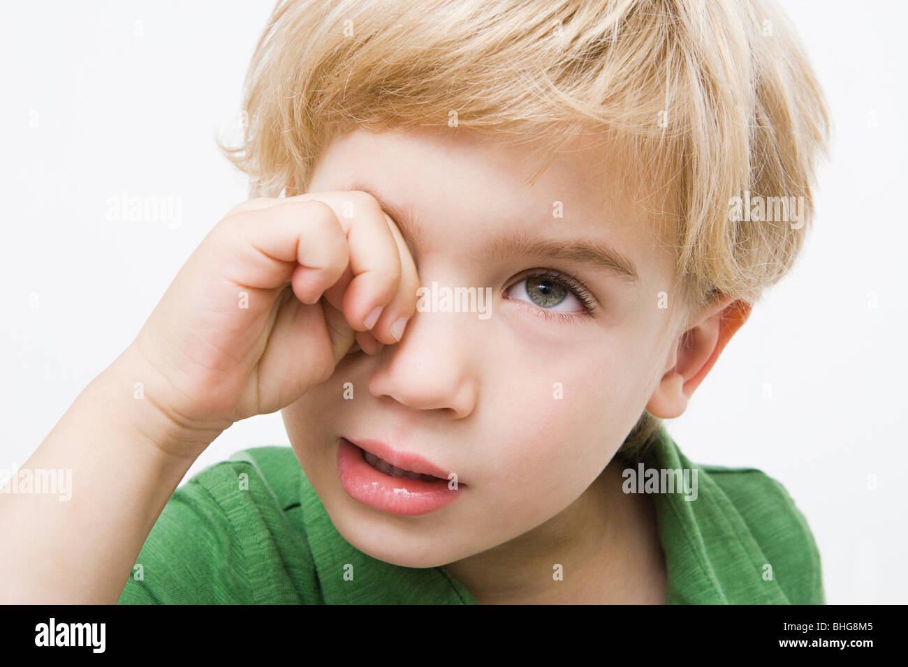 Boy rubbing eye Stock Photo Alamy