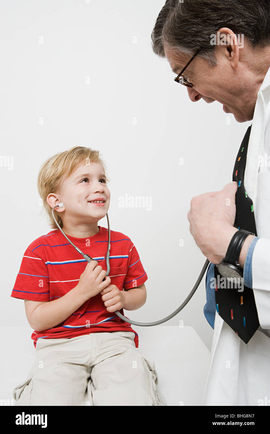 Boy and doctor with stethoscope Stock Photo Alamy