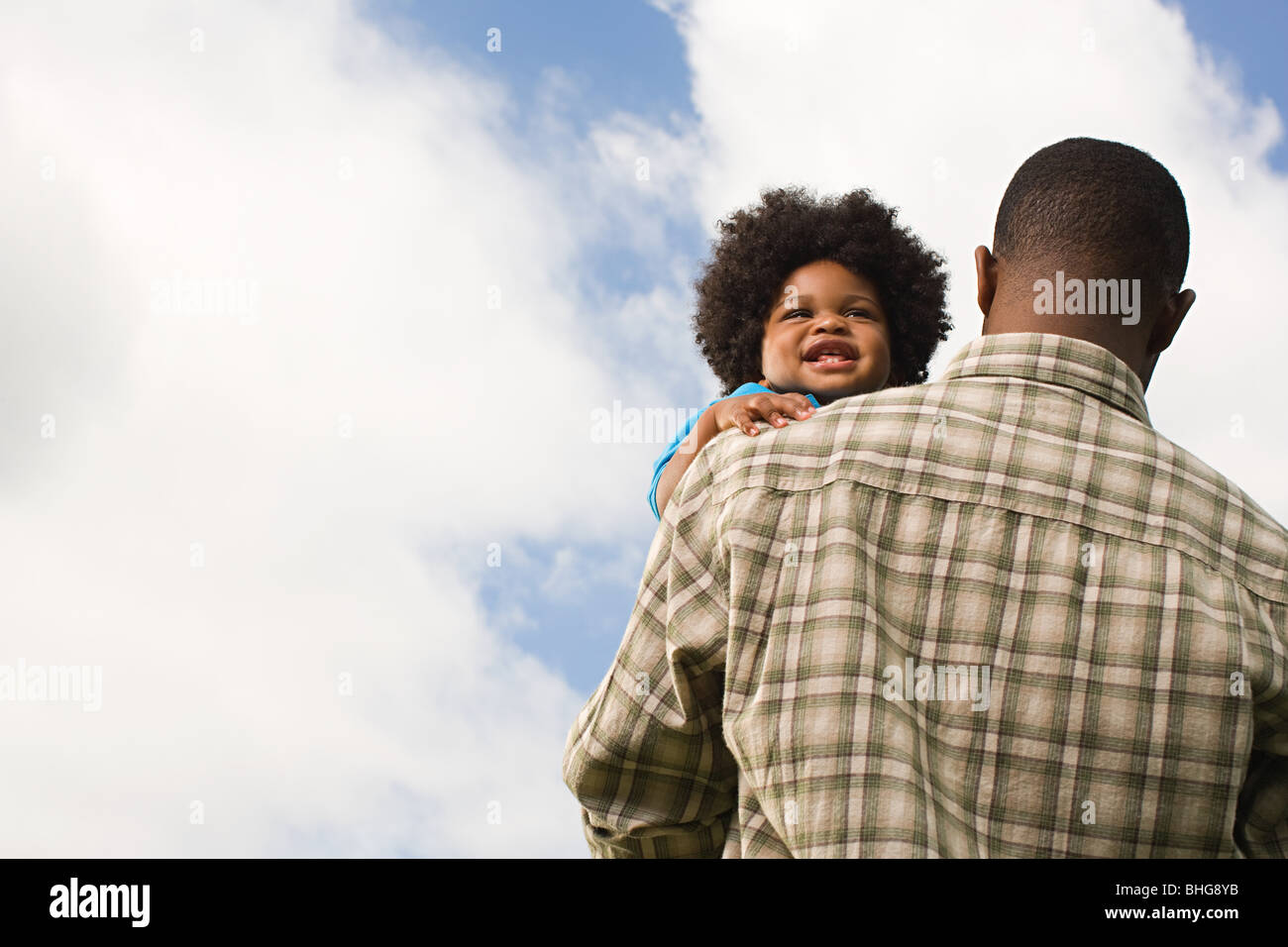 Baby being carried by father Stock Photo Alamy