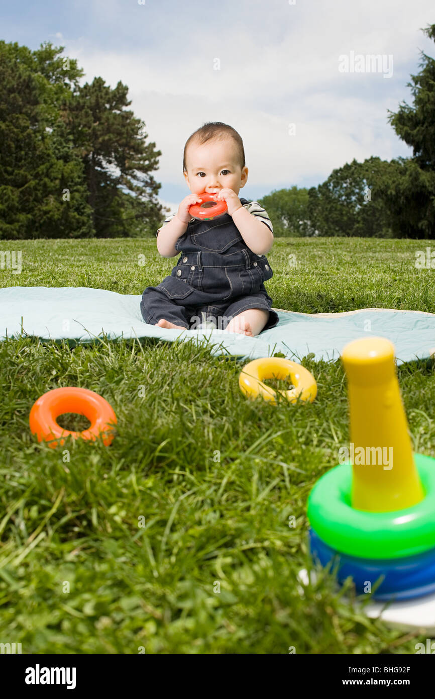 Baby boy in park with toy rings Stock Photo