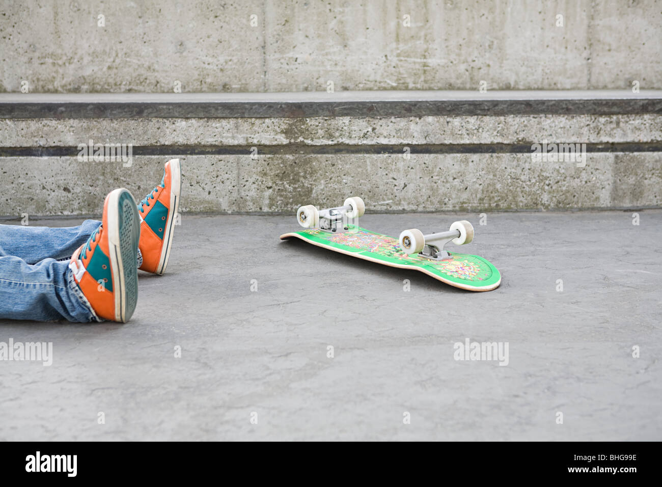 Feet of teenager who has fallen off skateboard Stock Photo - Alamy
