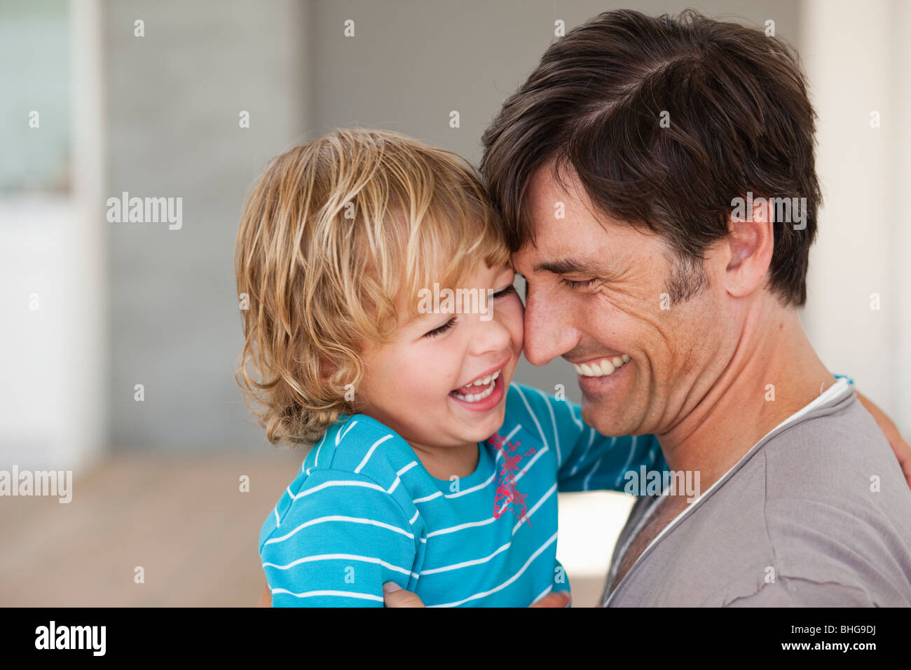 father tickling son Stock Photo