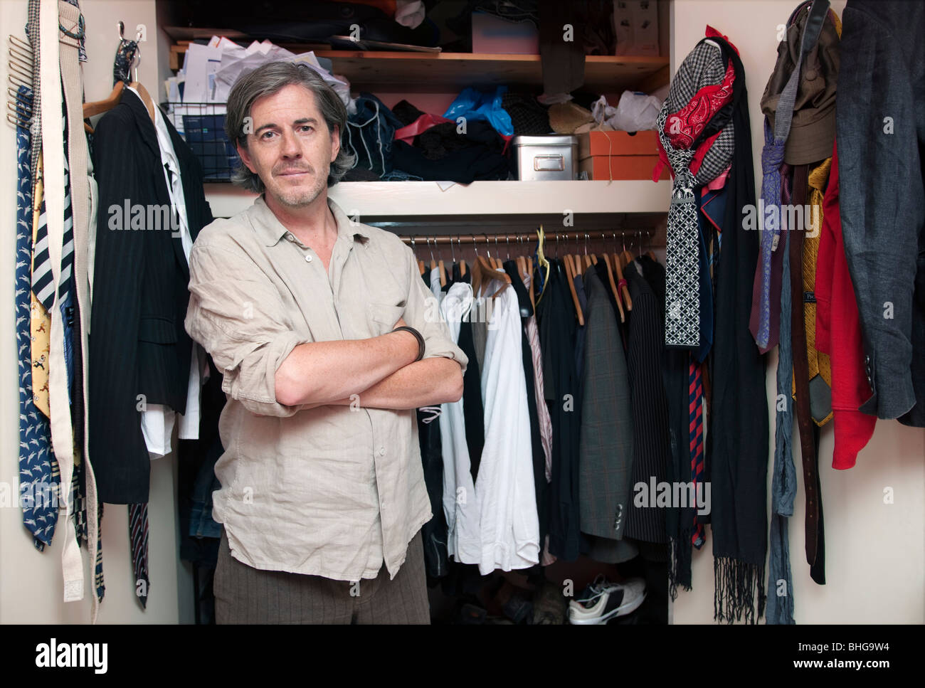 man in front of wardrobe Stock Photo