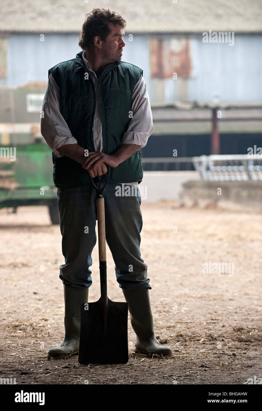 farmer relaxing with shovel Stock Photo - Alamy