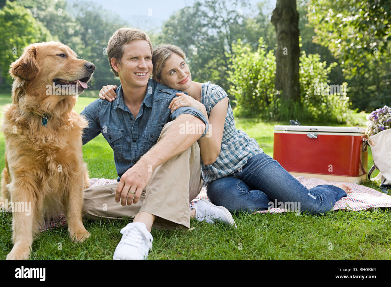 Couple having picnic with their dog Stock Photo - Alamy