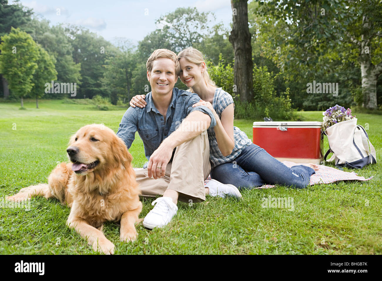 Couple having picnic with their dog Stock Photo - Alamy
