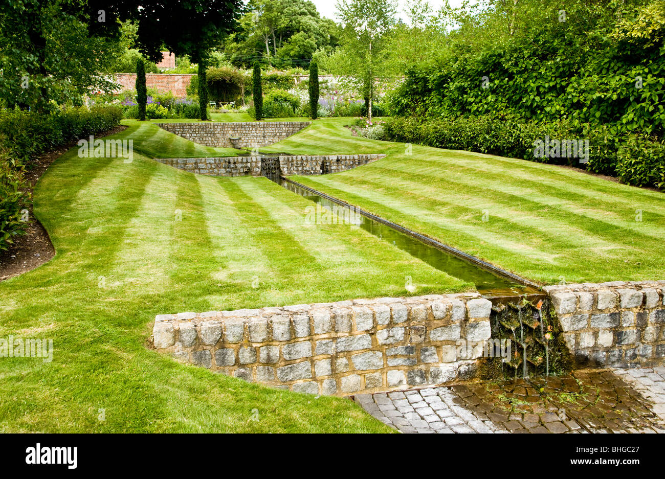 A water feature or rill in an English country garden on a summer's day. Stock Photo