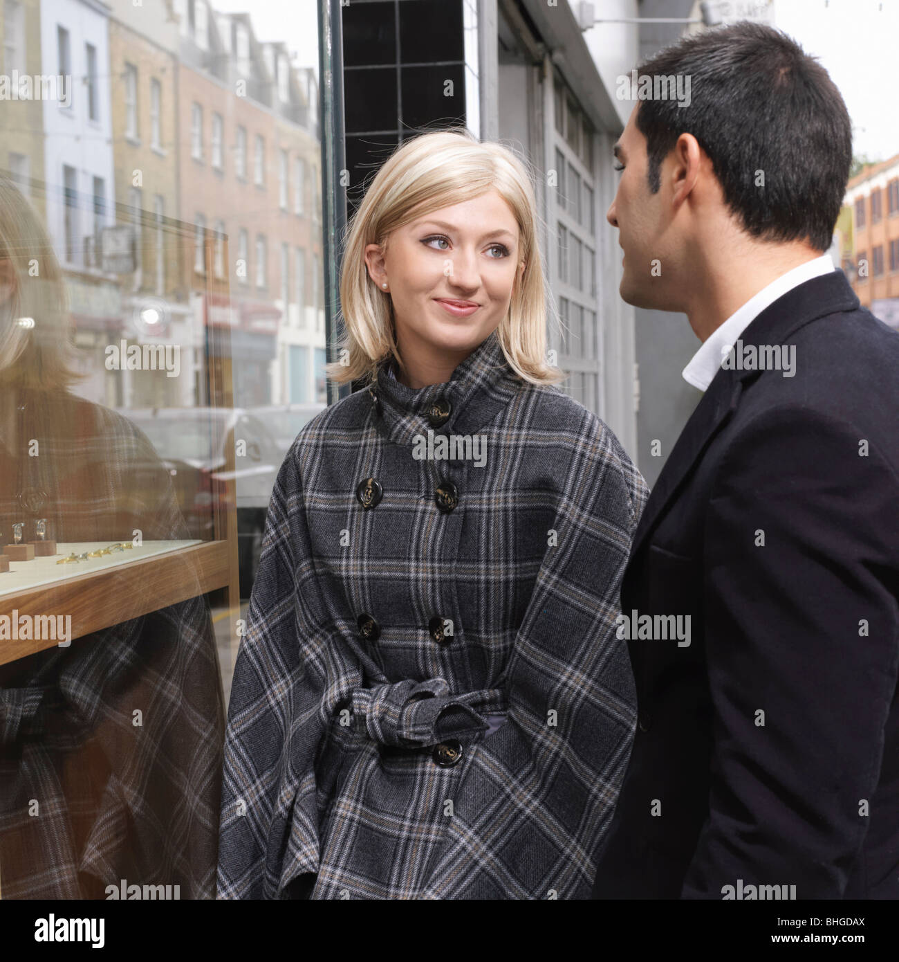 couple in front of shop window Stock Photo
