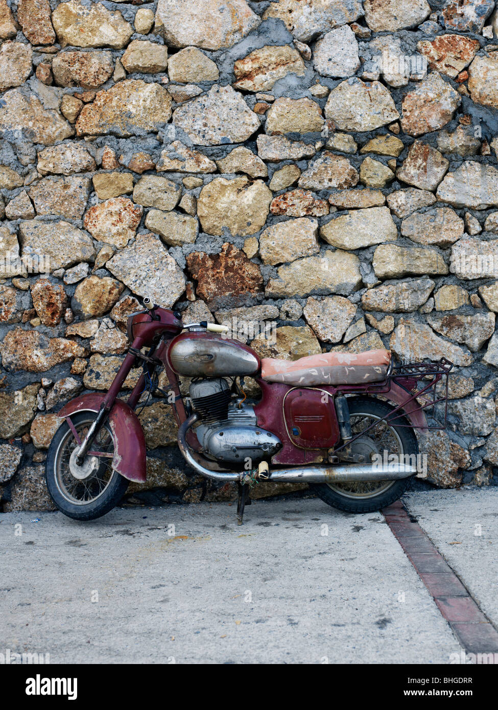 An old motorcycle against a stone wall hi res stock photography and images Alamy
