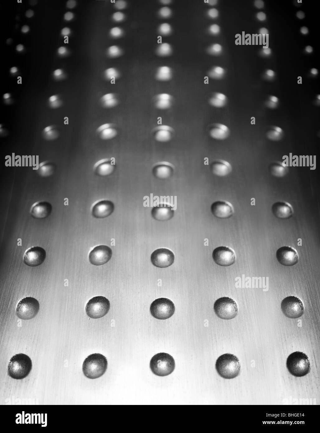 dark metal surface background with repetition holes Stock Photo
