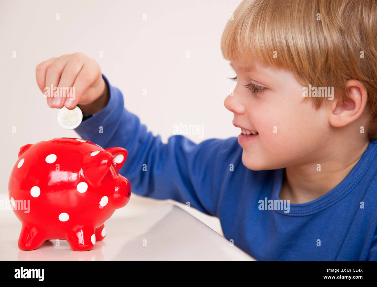 boy saving money Stock Photo