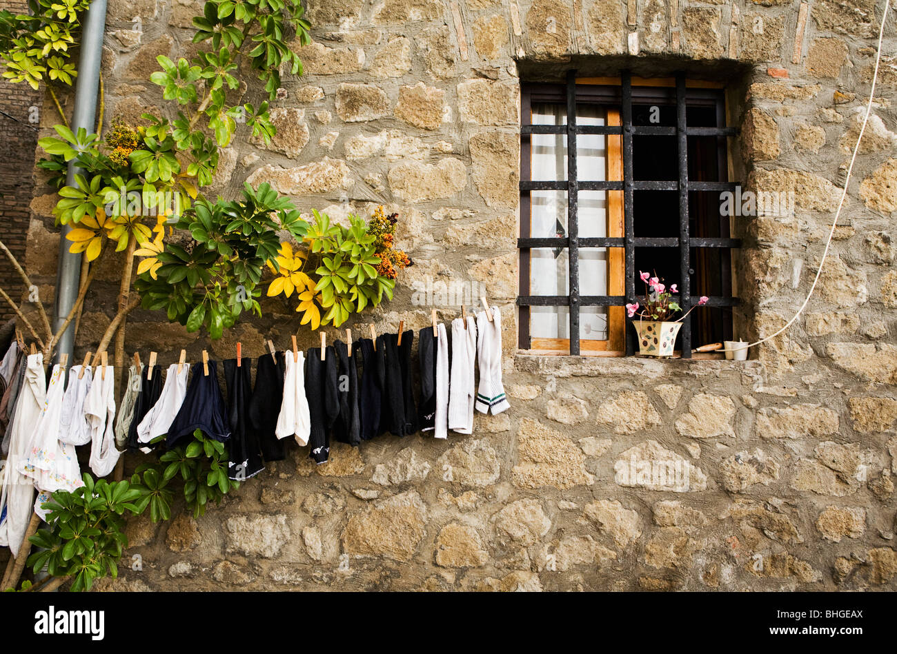Clothesline on a stone wall, Italy Stock Photo Alamy