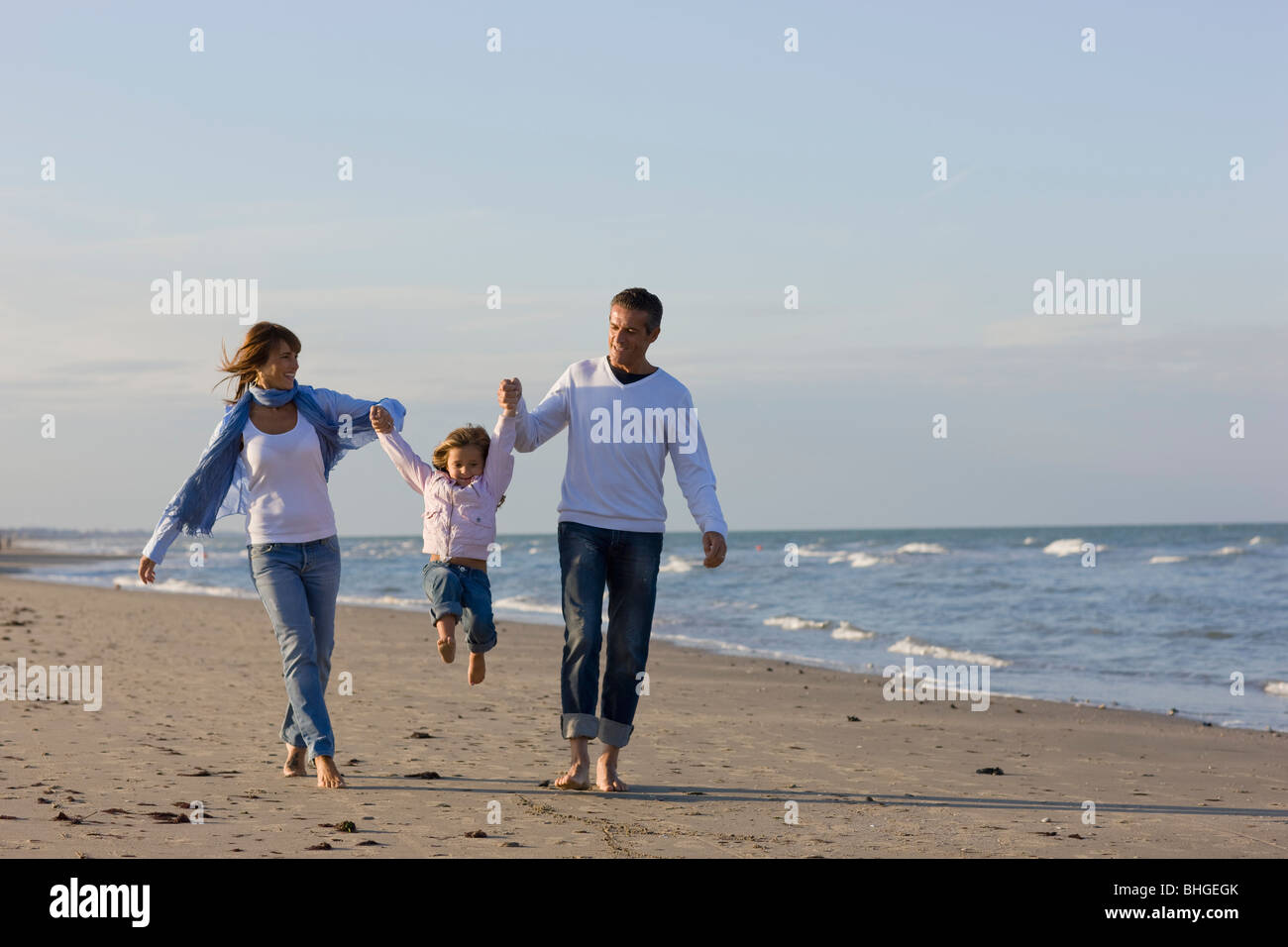 Child swinging from parents hands hires stock photography and images