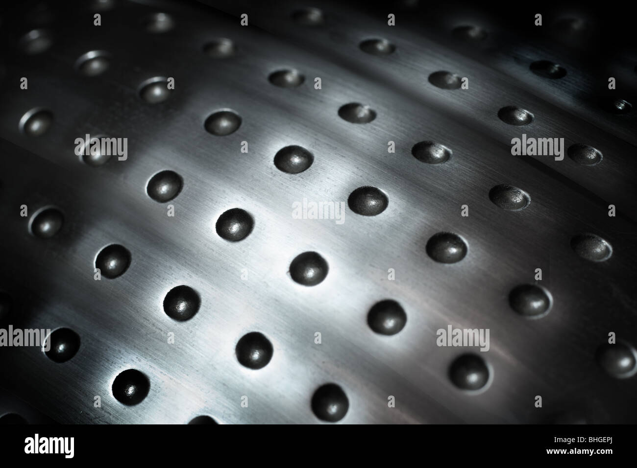 spherical metal surface background with repetition holes Stock Photo