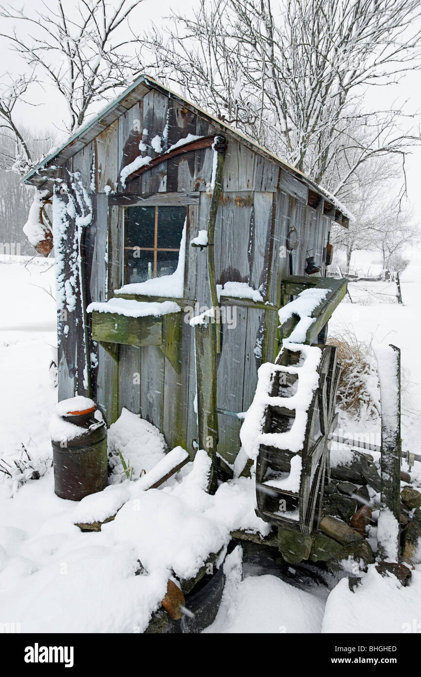 The shed with the stilled water wheel sits in a rural setting in the Midwestern United States. Stock Photo