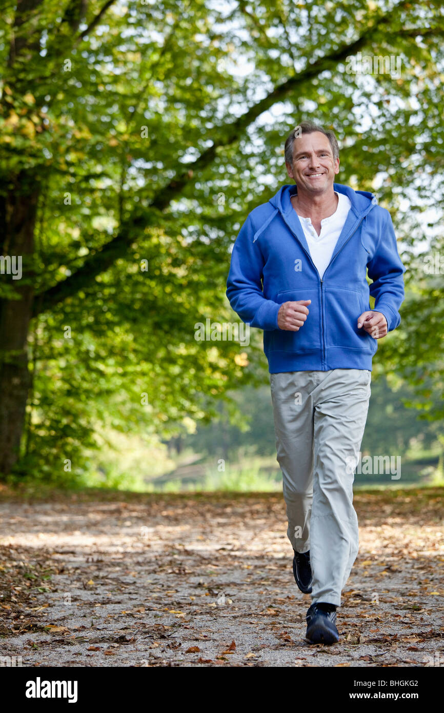 Middle aged man jogging Stock Photo