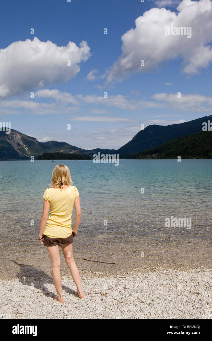 A young woman standing by a lake Stock Photo