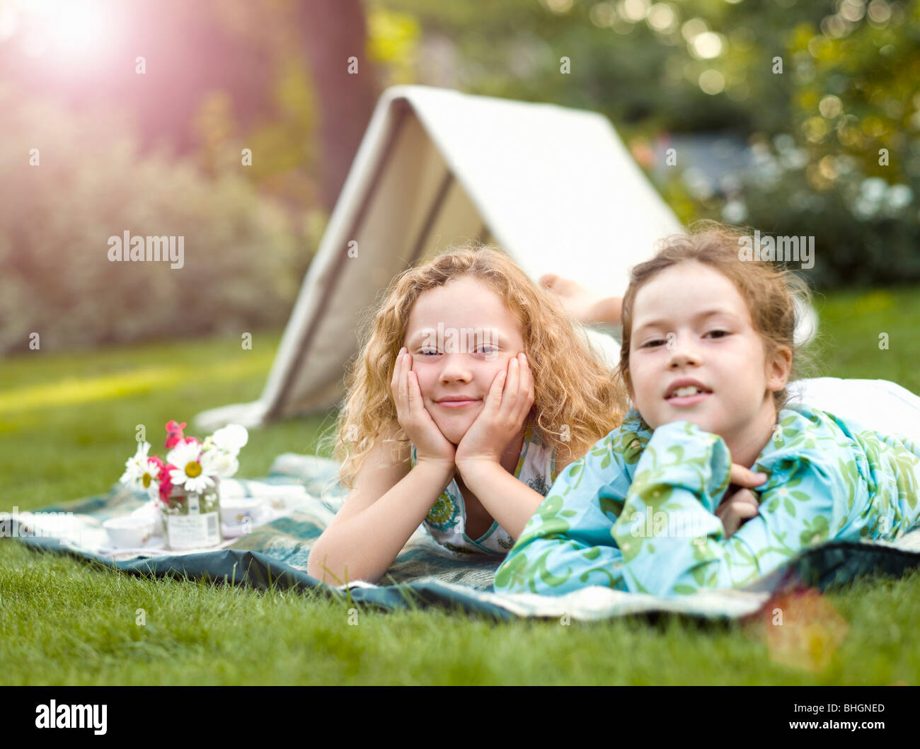 Two girls smiling at play picnic Stock Photo Alamy