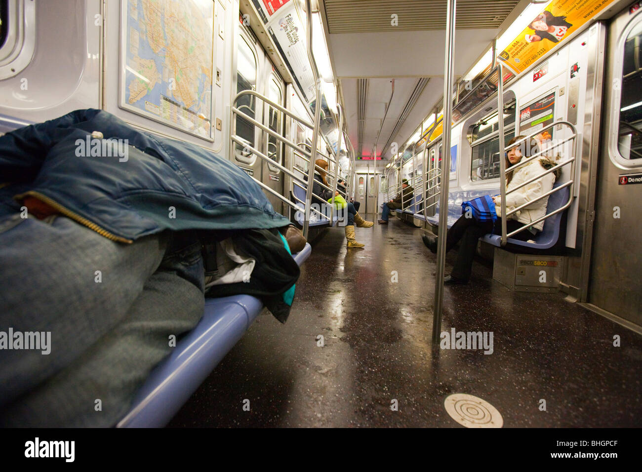 Homeless man sleeping on the subway in New York City Stock Photo