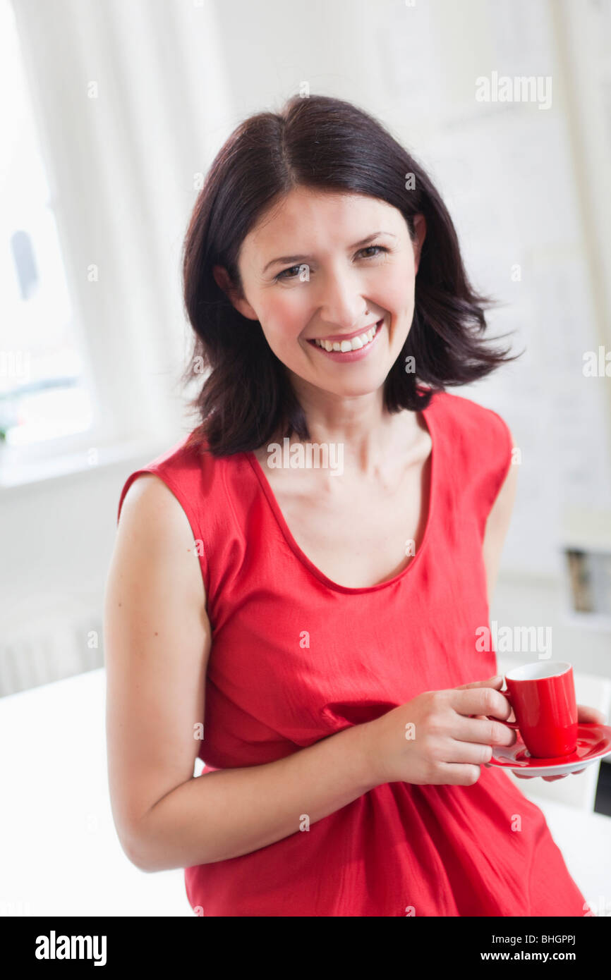 woman in red dress holding red cup Stock Photo - Alamy