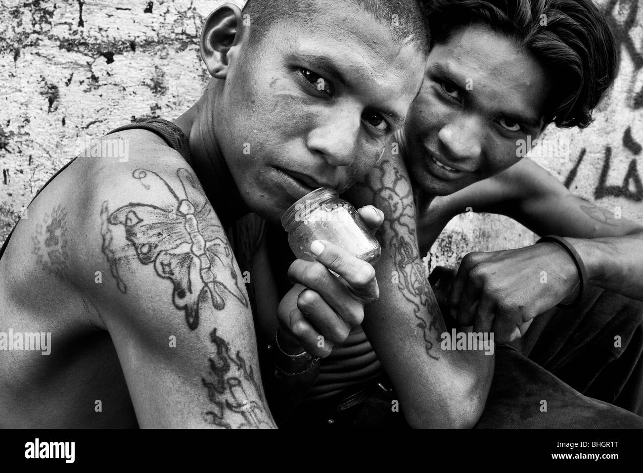 Young Nicaraguan boys living on the street and sniffing the shoe glue, Managua, Nicaragua. Stock Photo