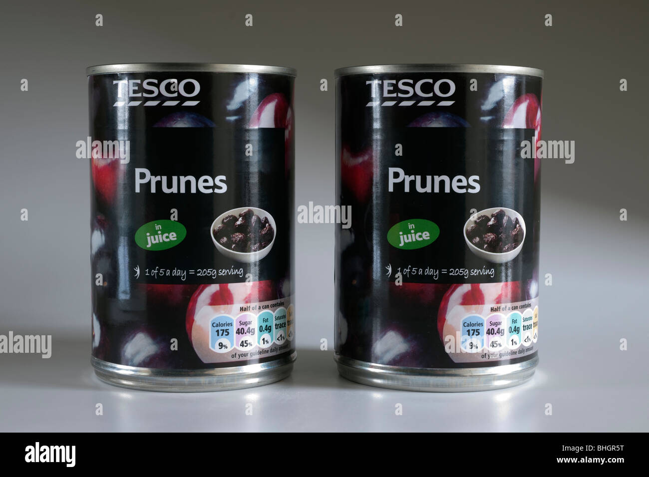 Two tins of Tesco prunes in juice Stock Photo