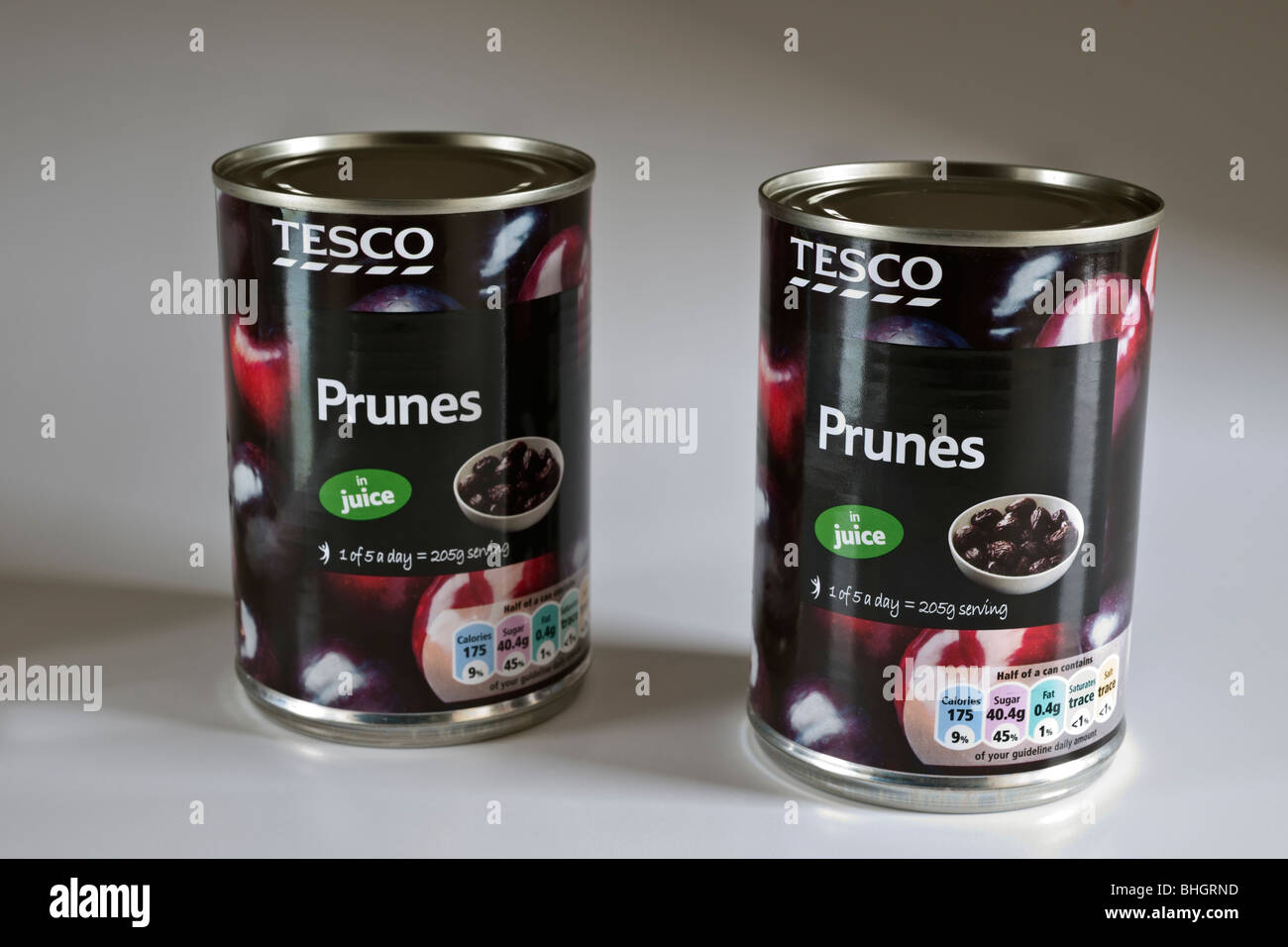 Two tins of Tesco prunes in juice Stock Photo Alamy