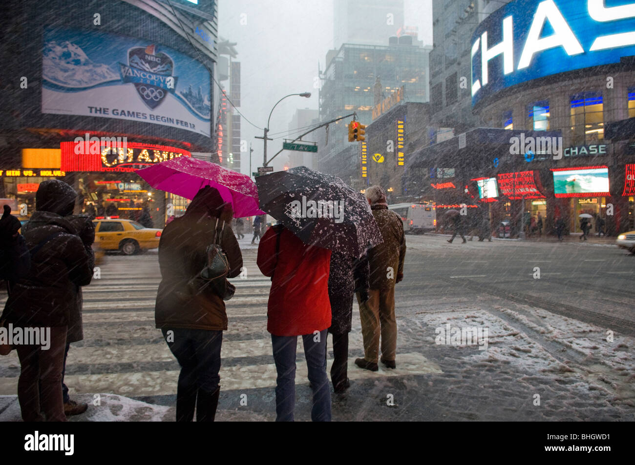 Visitors and New Yorkers maneuver through Times Square in New York during a storm that is covering the East Coast Stock Photo