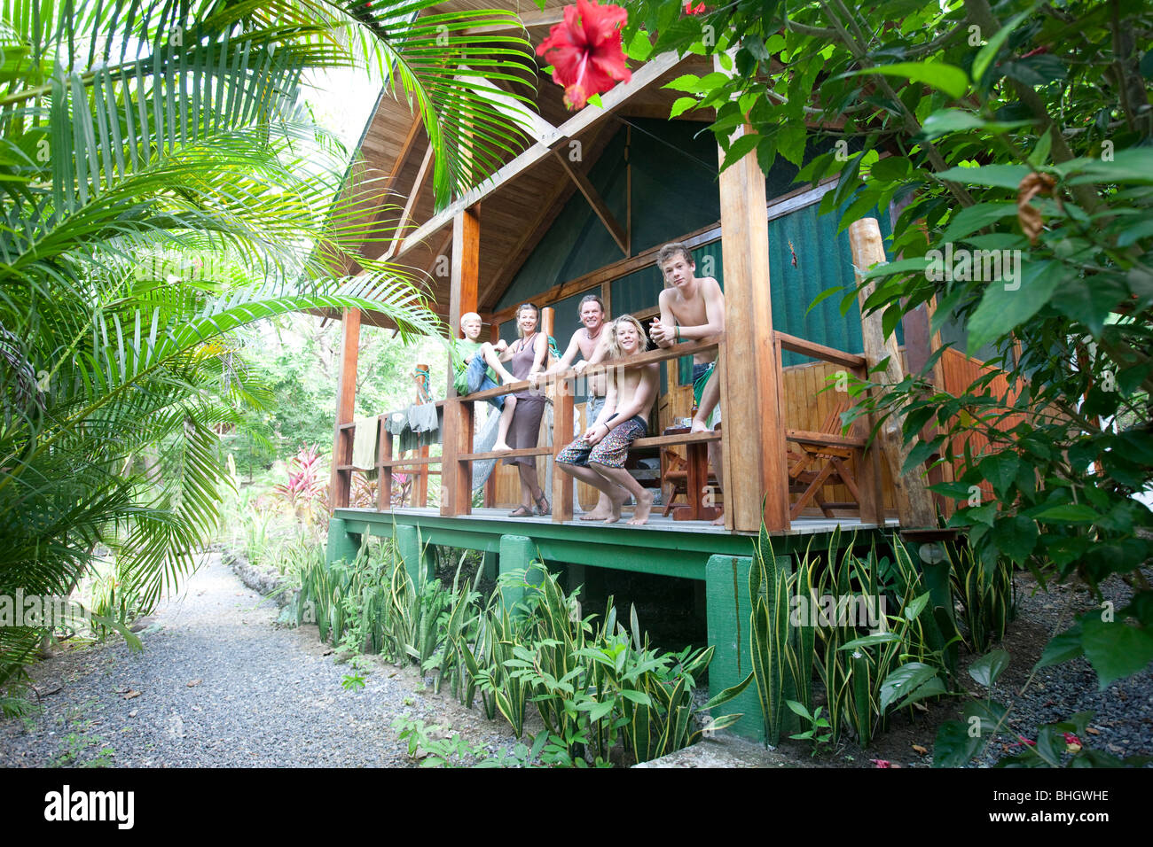 Family in their jungle cabin, Mal Pais, Costa Rica Stock Photo