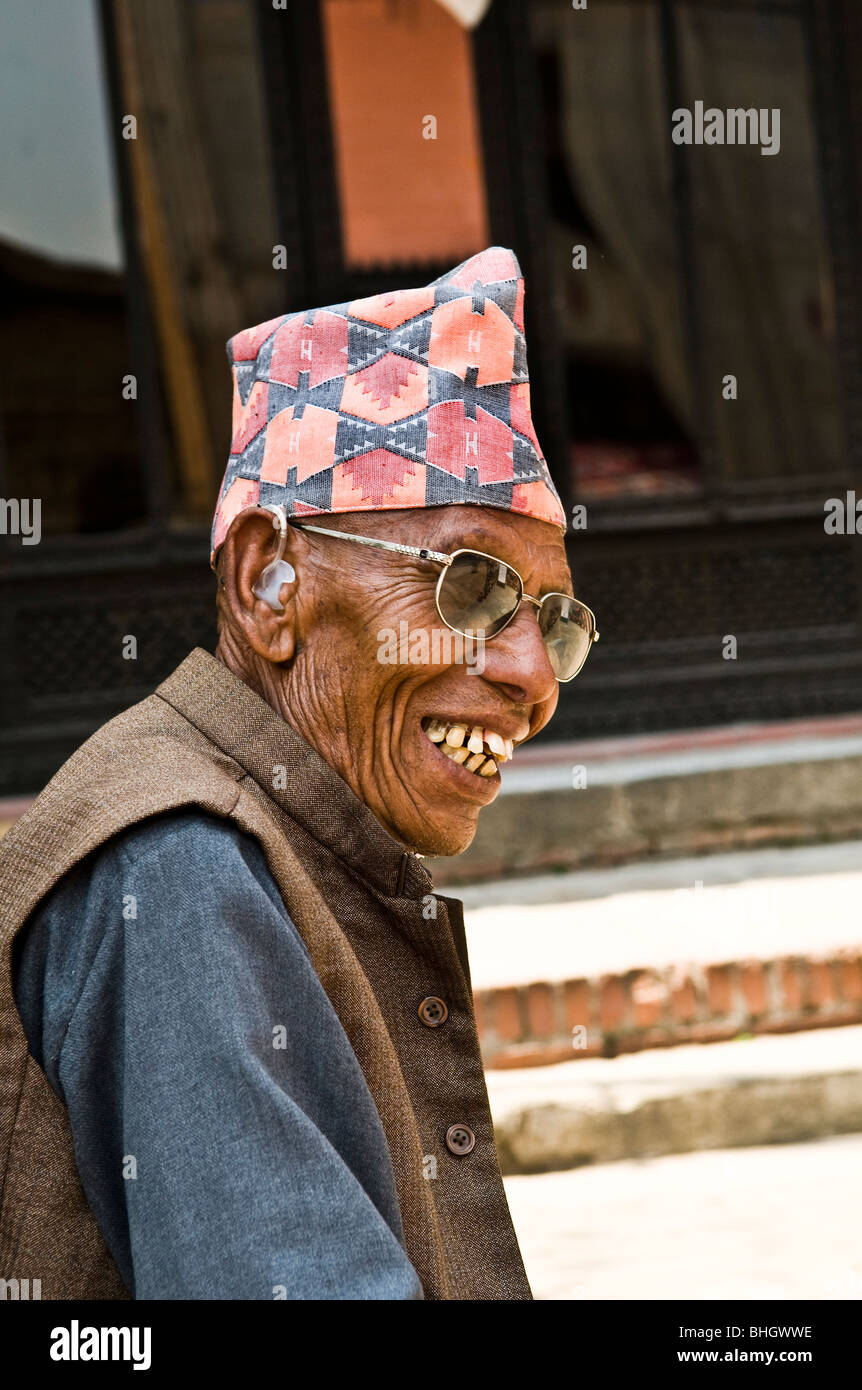 A smiling Nepalese man wearing a local cap. Stock Photo