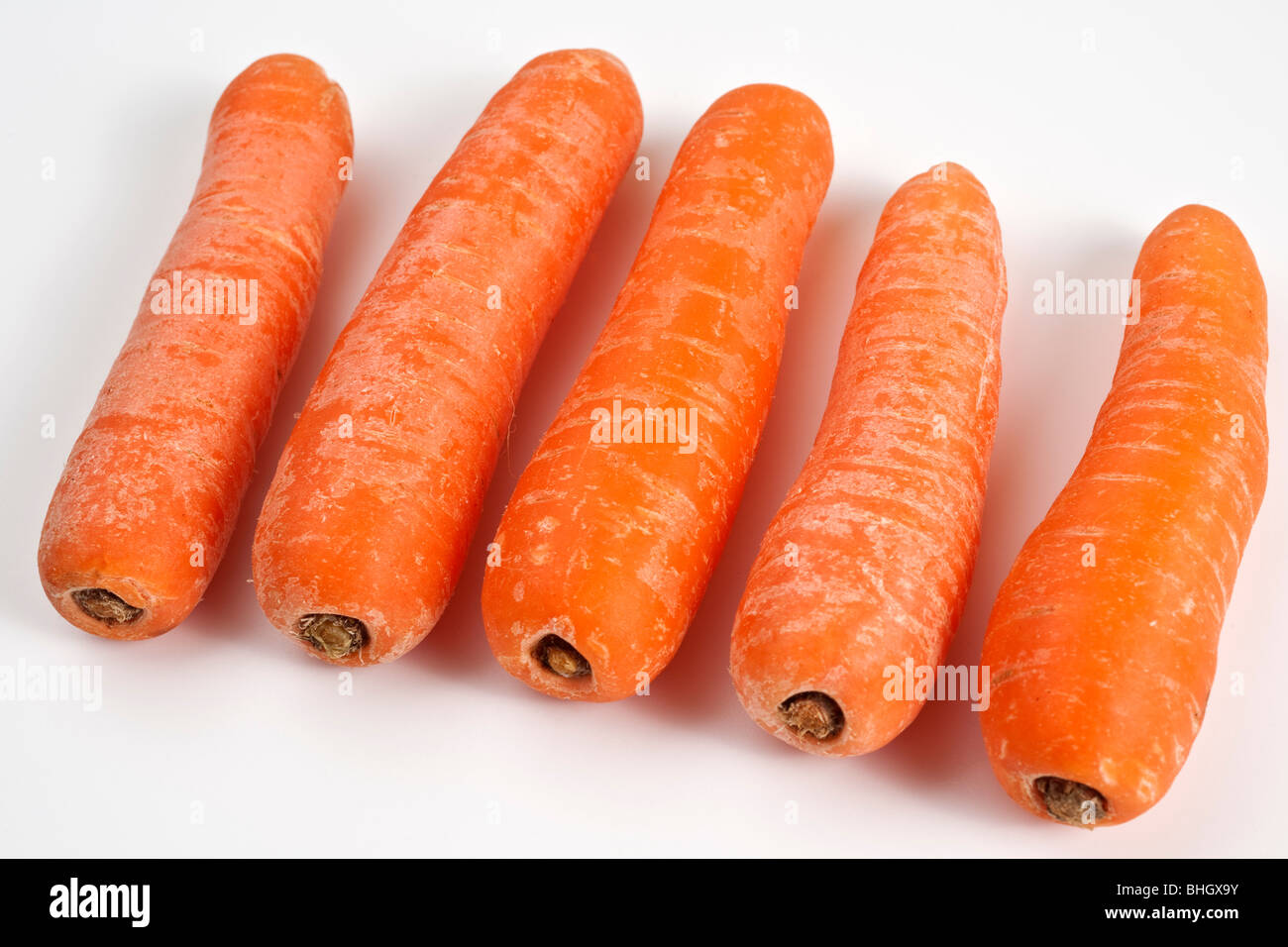 Five unpeeled carrots Stock Photo