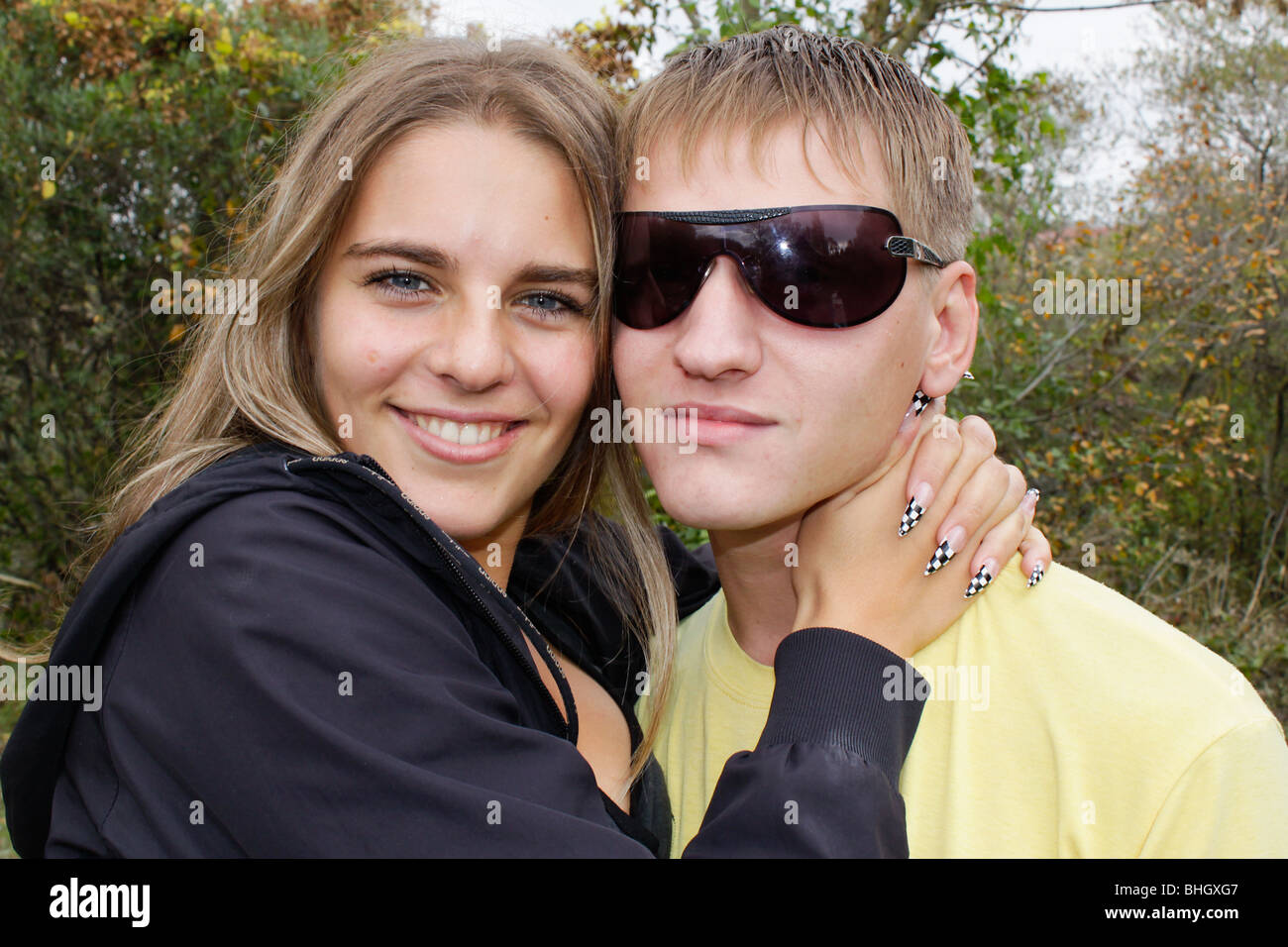 Portrait of young hugging couple outdoors Stock Photo - Alamy