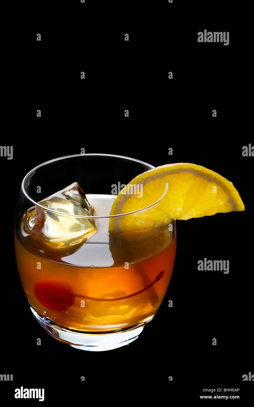 Old Fashioned mixed drink with orange slice and cherry garnish on a