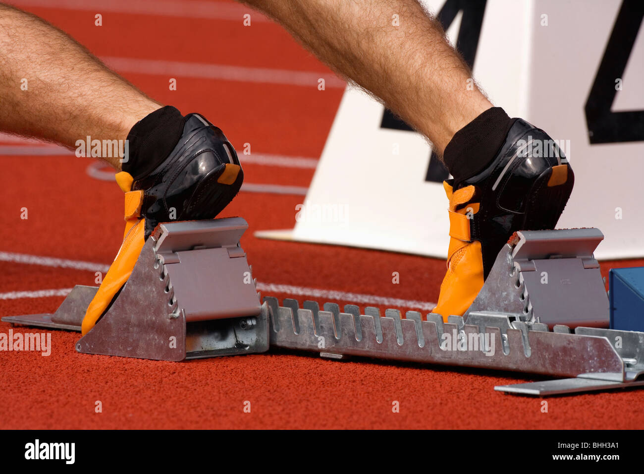 sport - runner at starting block in running competition Stock Photo