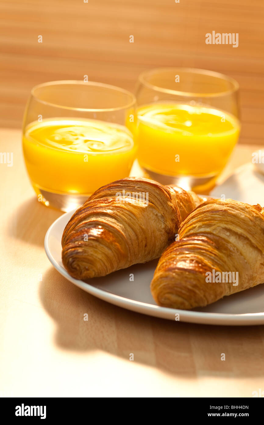 A healthy continental breakfast of croissant pastries, orange juice