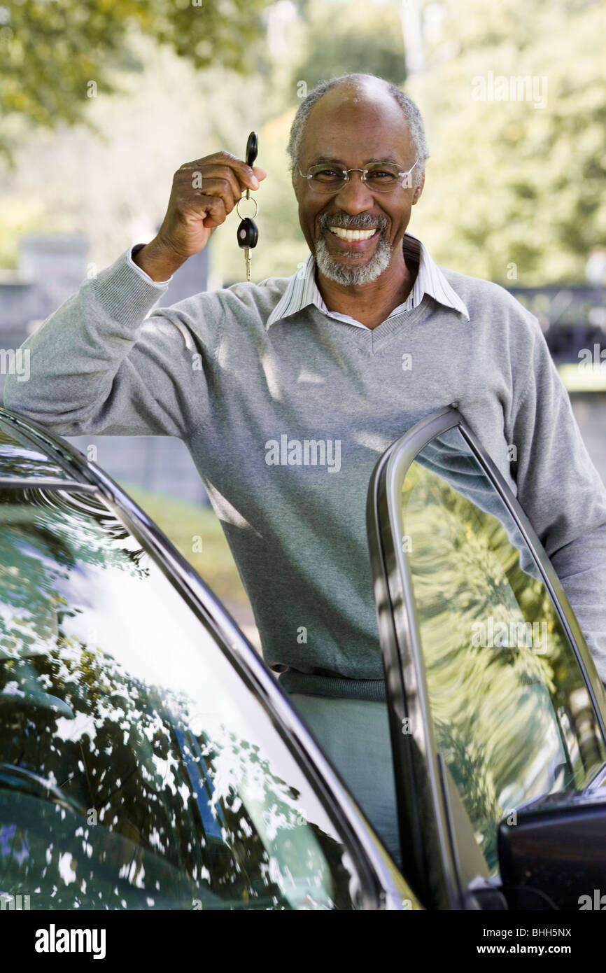 Senior man holding a car key, Sweden. Stock Photo