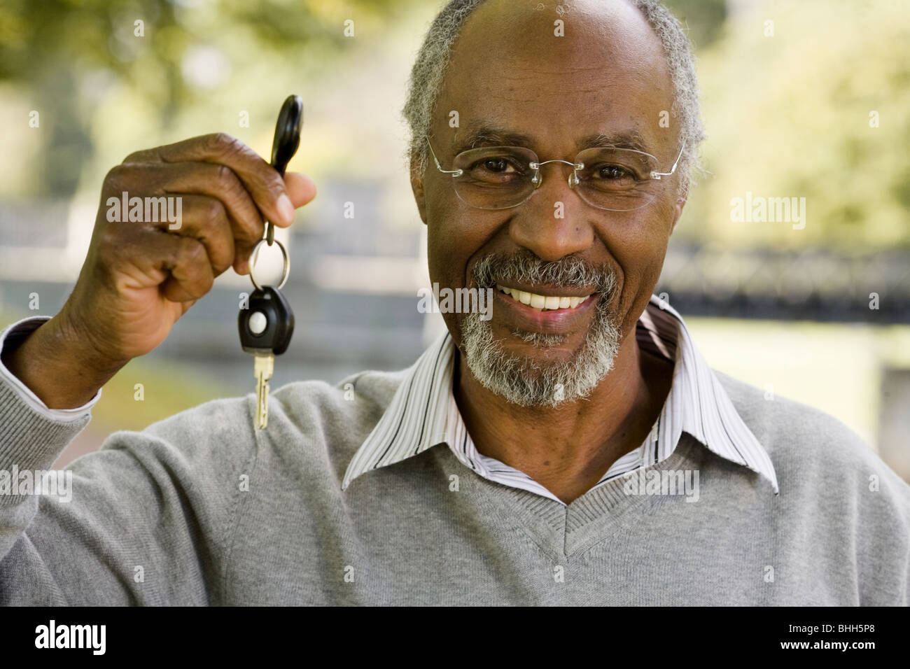 Senior man holding a car key, Sweden. Stock Photo