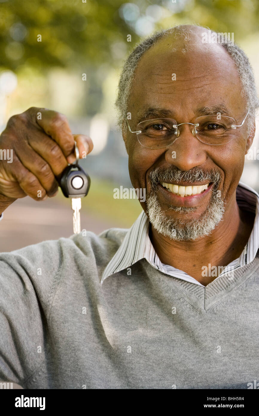 Senior man holding a car key, Sweden. Stock Photo
