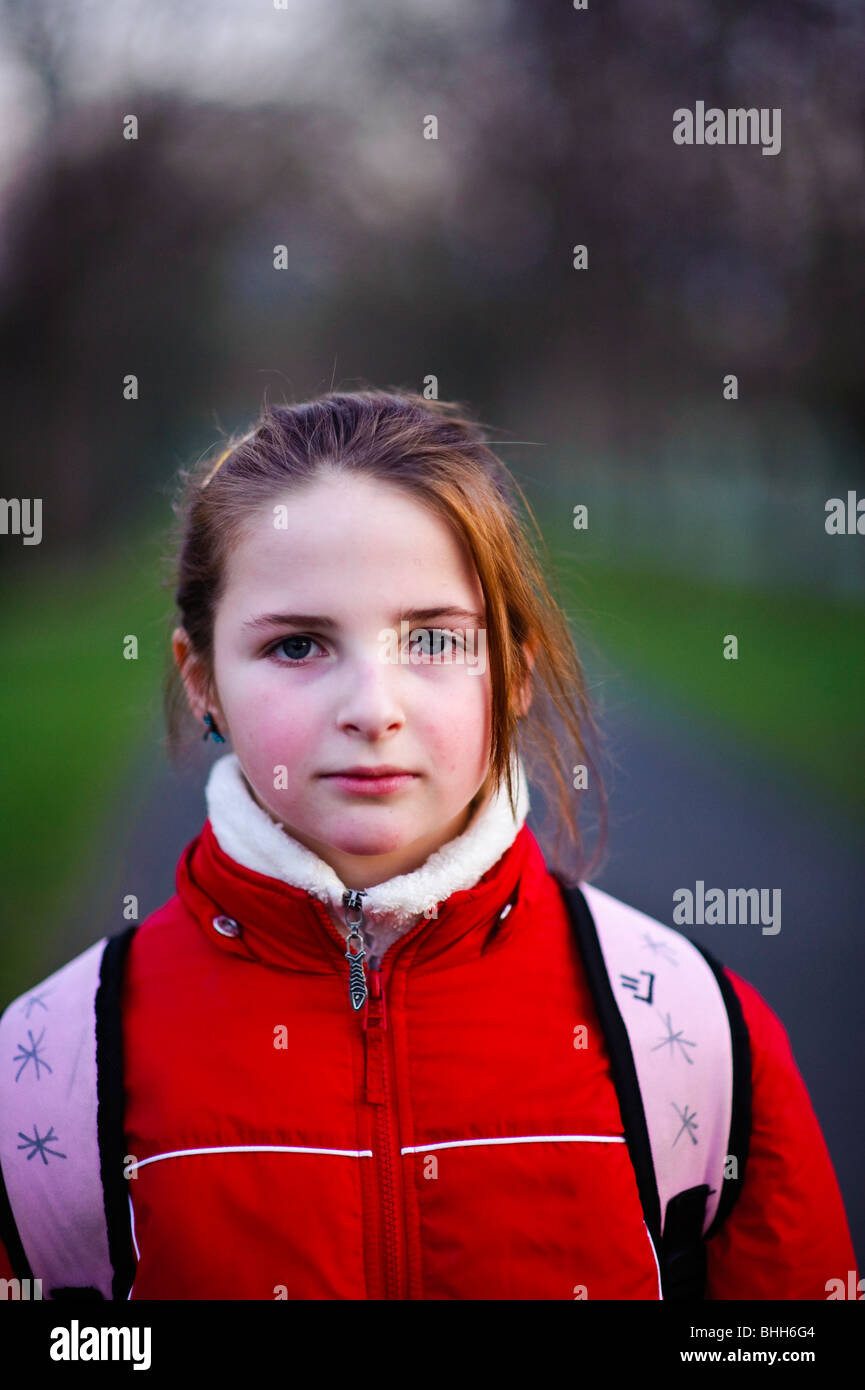 Ten year old girl, looking straight ahead, UK on a cold day Stock Photo