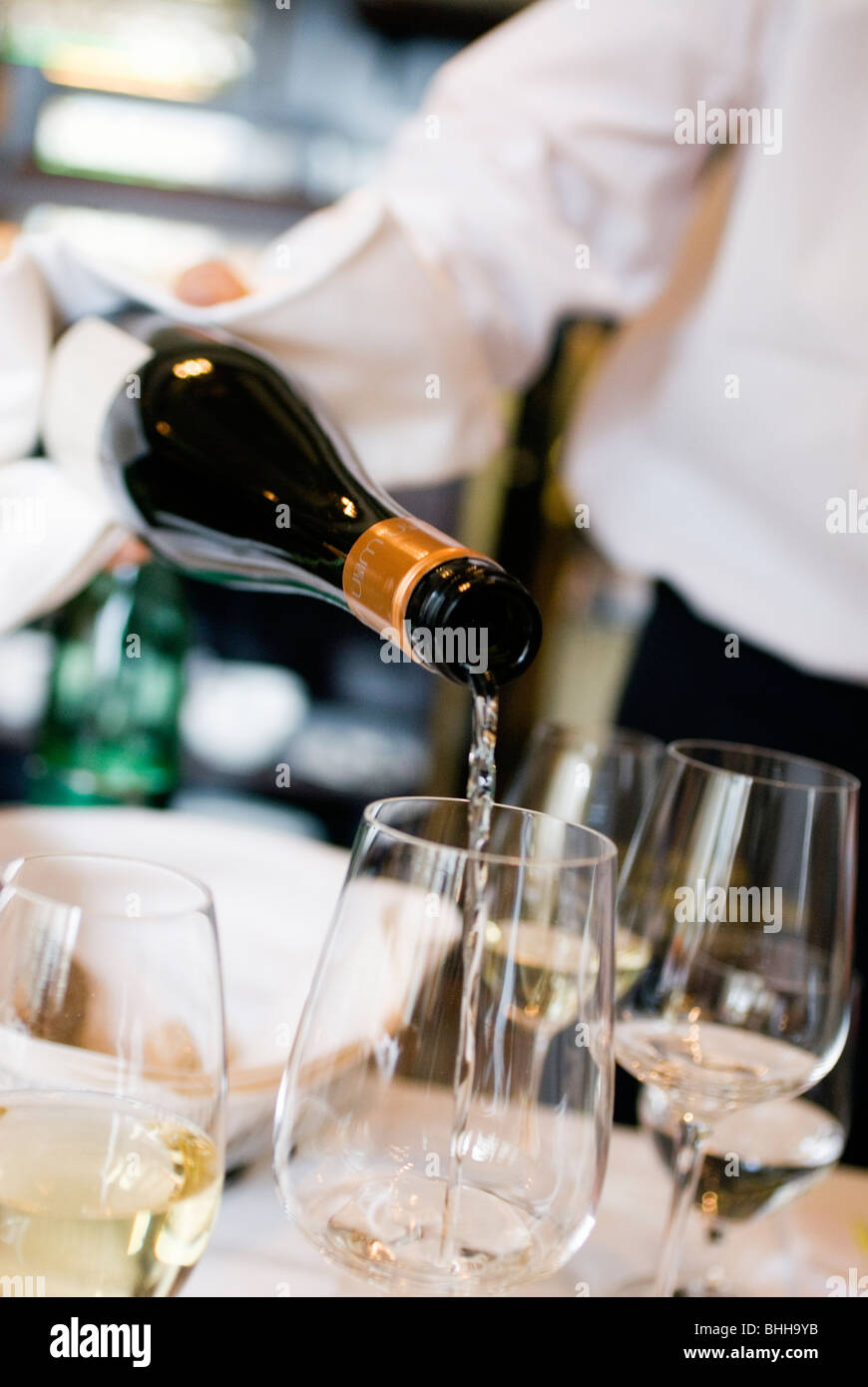 A waiter pouring wine in a glass Stock Photo Alamy