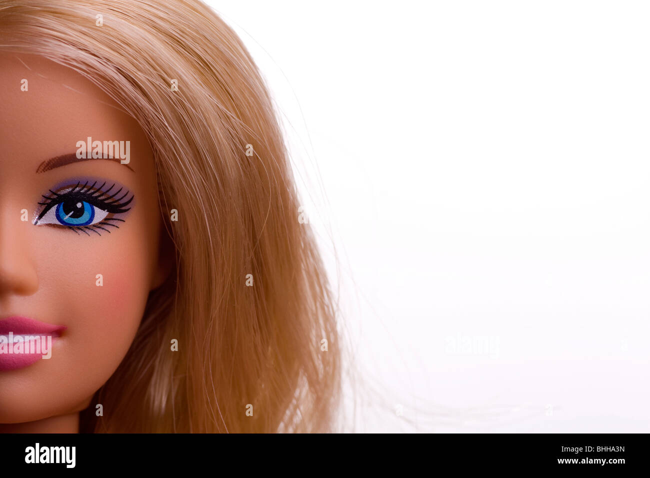 Close-up of a Barbie doll face with blonde hair & blue eyes Stock Photo