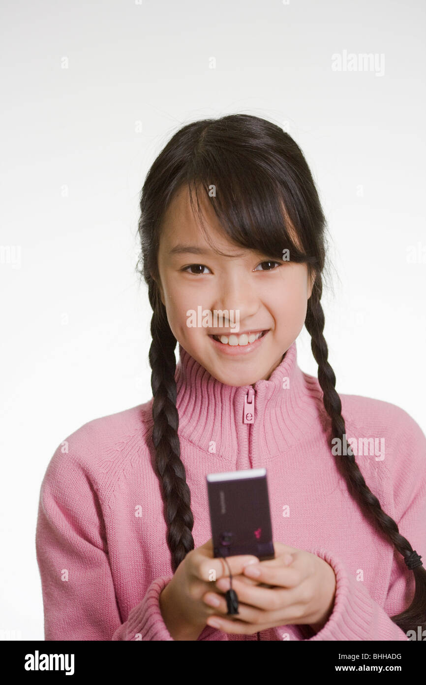 Happy girl using a mobile phone. Stock Photo