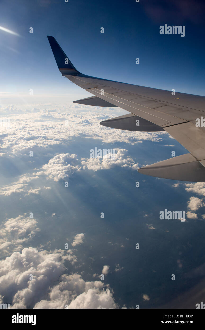 The wing of an aeroplane and blue sky. Stock Photo